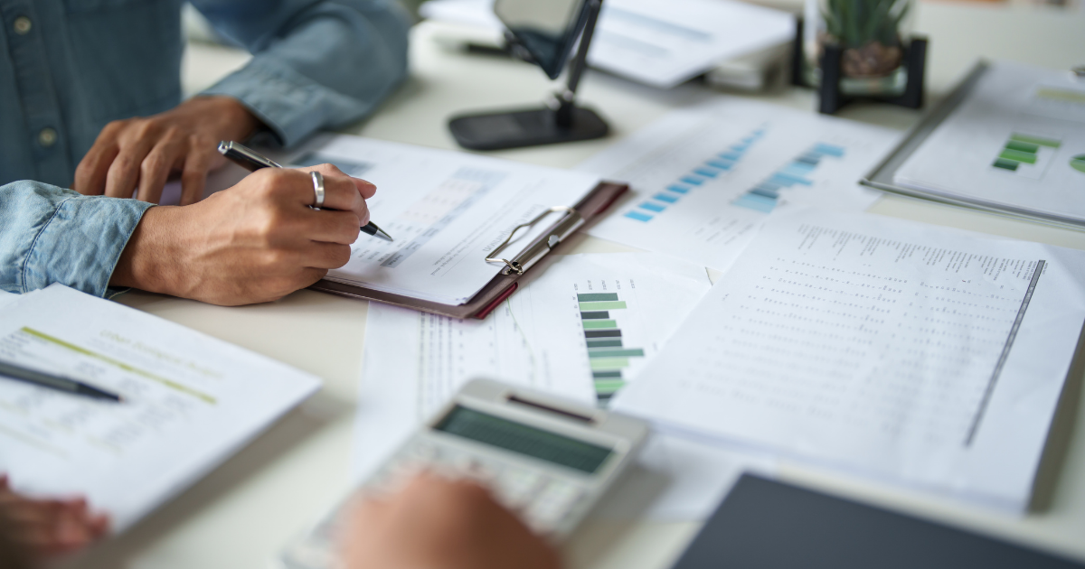 Woman doing paperwork while learning about the importance of Beneficiary Designations